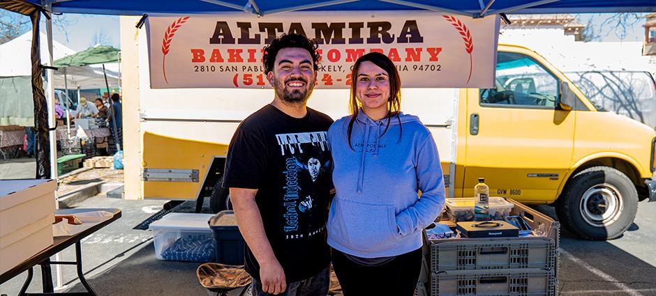 Altamira baking sellers in their booth at the Pinole Farmers' Market