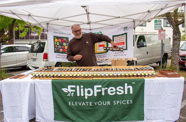 Owner of FlipFresh holding spices upside down in his magnetized spice rack
