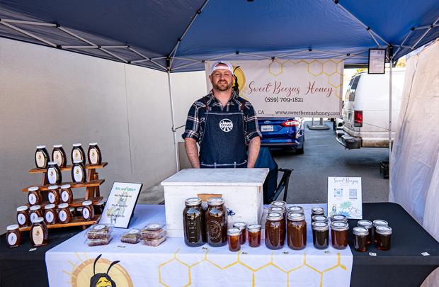 The owner of Sweet Beezus honey at their booth at the Pinole Farmers' Market