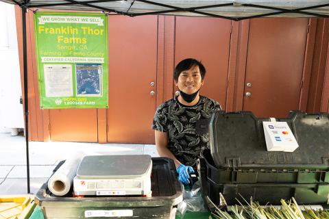 Franklin Thor vendor smiling behind cash register