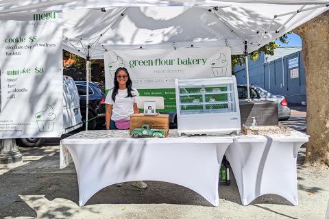 Smiling vendor at Green Flour Bakery stall at Concord Farmers' Market
