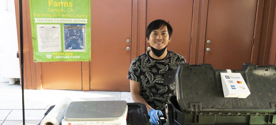 Franklin Thor vendor smiling behind cash register 