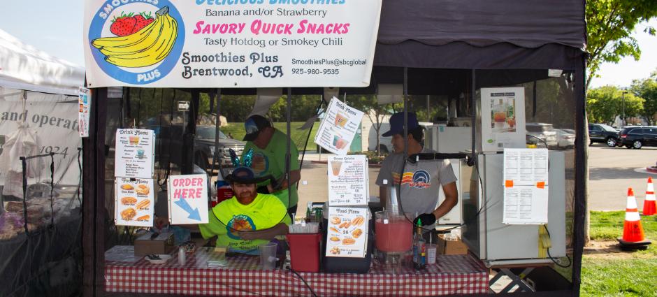 Picture of smoothies plus workers inside stall