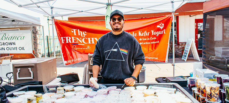 Producer smiling at stall in the market