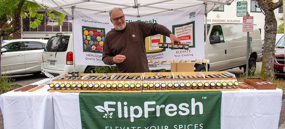 Owner of FlipFresh holding spices upside down in his magnetized spice rack