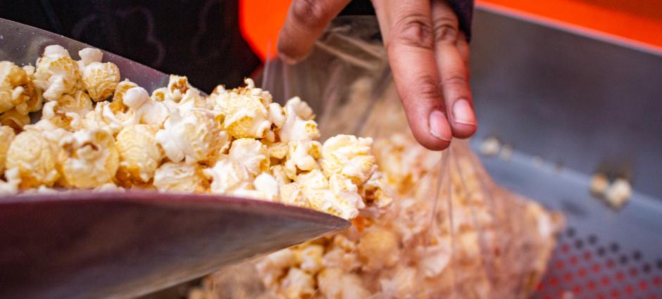 Photo of freshly popped kettle corn being put into bag