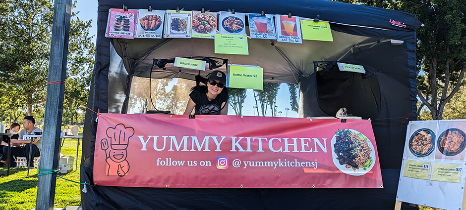 Yummy Kitchen owner smiling at the market