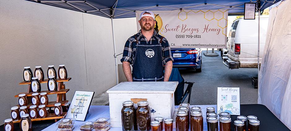 The owner of Sweet Beezus honey at their booth at the Pinole Farmers' Market