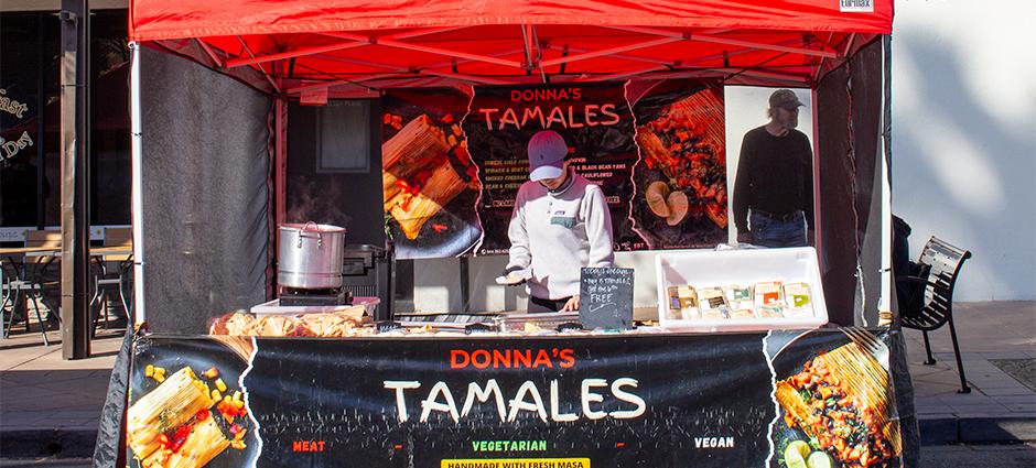 Donna's Tamales worker at her booth in the Brentwood Farmers' Market