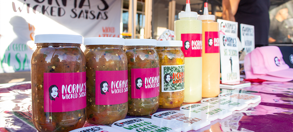 Salsas and sauces from Norma's Wicked Salsa at their colorfully decorated booth at the Brentwood Farmers' Market
