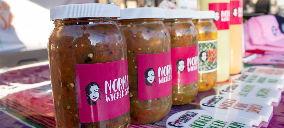 Salsas and sauces from Norma's Wicked Salsa at their colorfully decorated booth at the Brentwood Farmers' Market
